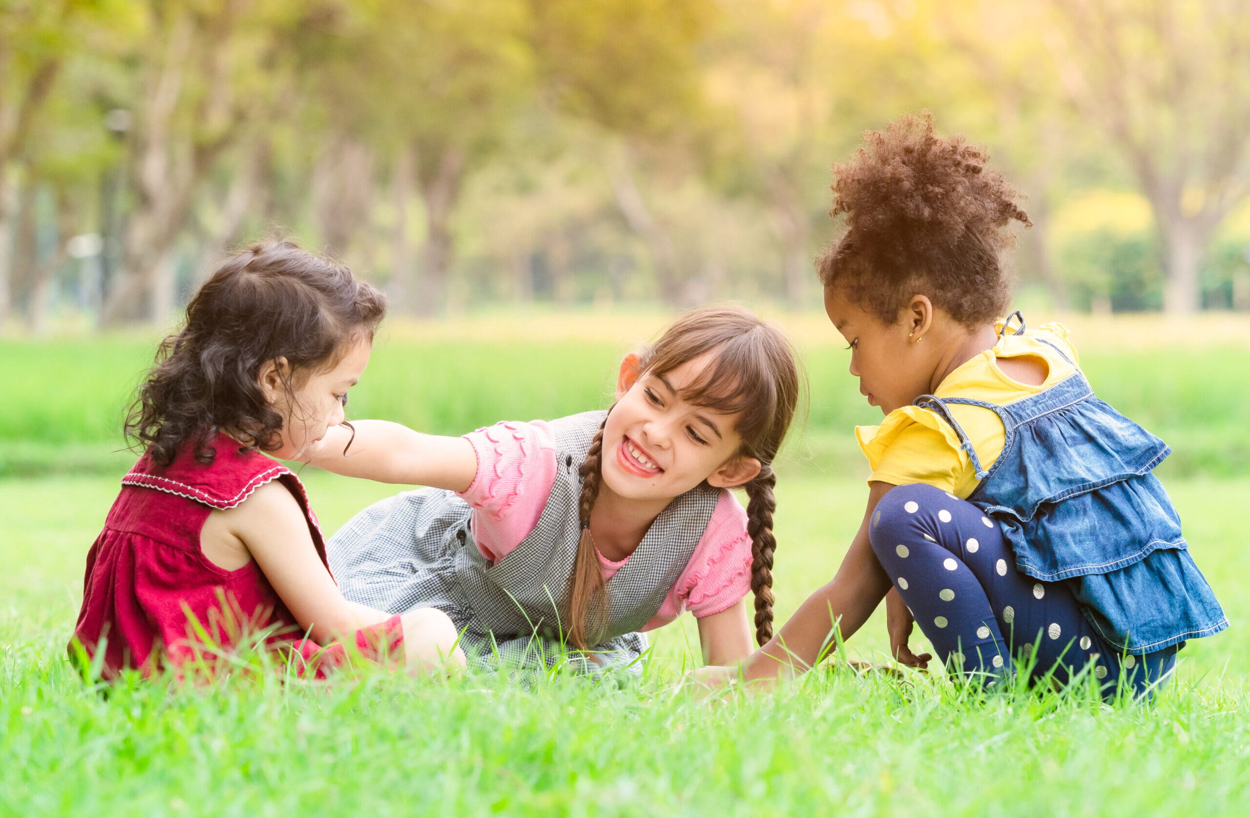 A group of young children of many nationalities play and learn o